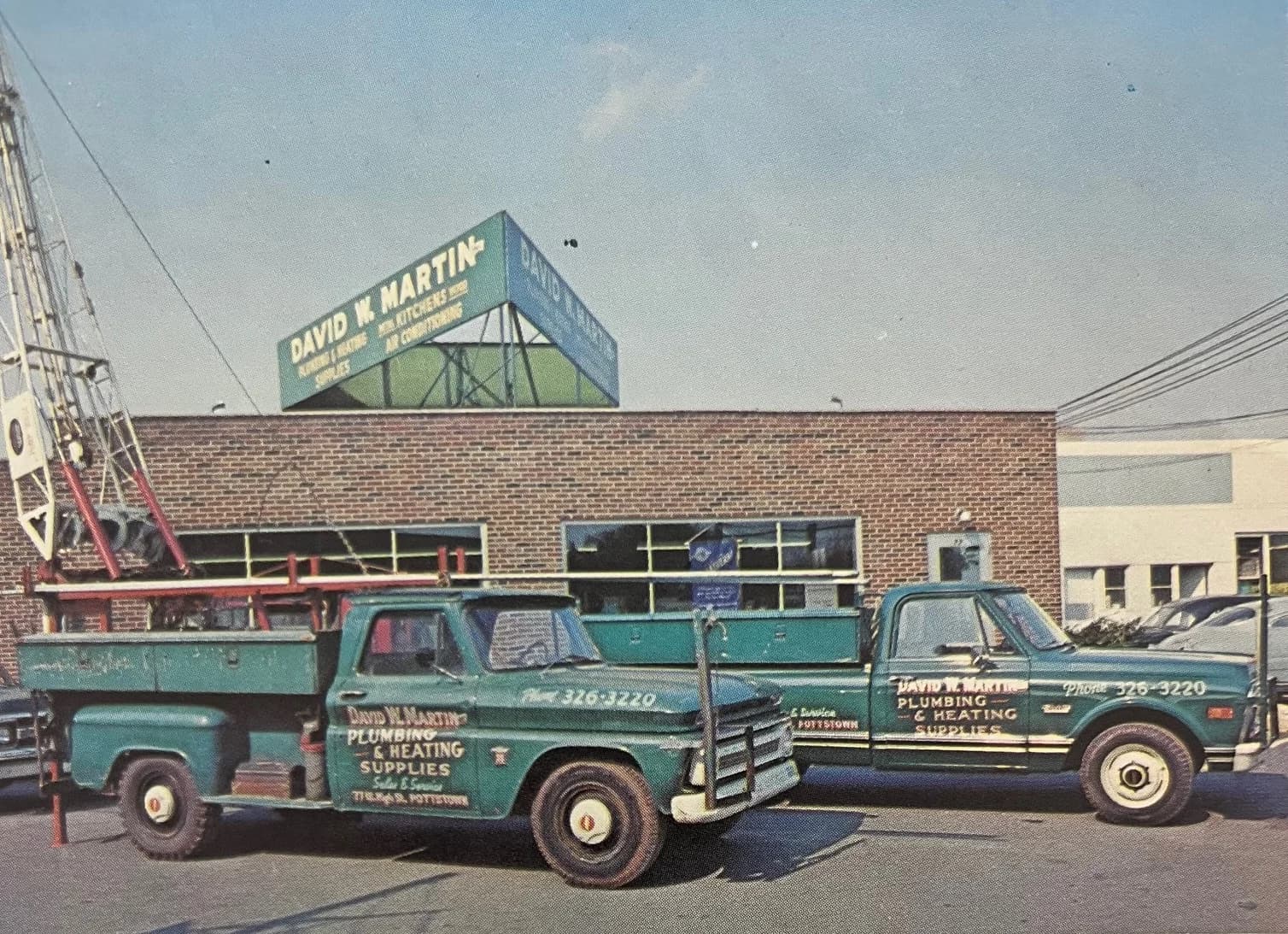Vintage green plumbing trucks outside Gary’s grandfather’s plumbing company and supply house in Pennsylvania