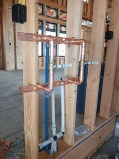 Copper pipe connections and supply lines within unfinished framing