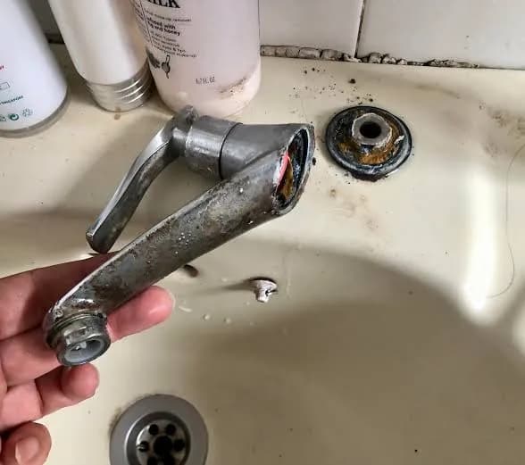 A broken faucet removed from a bathroom sink